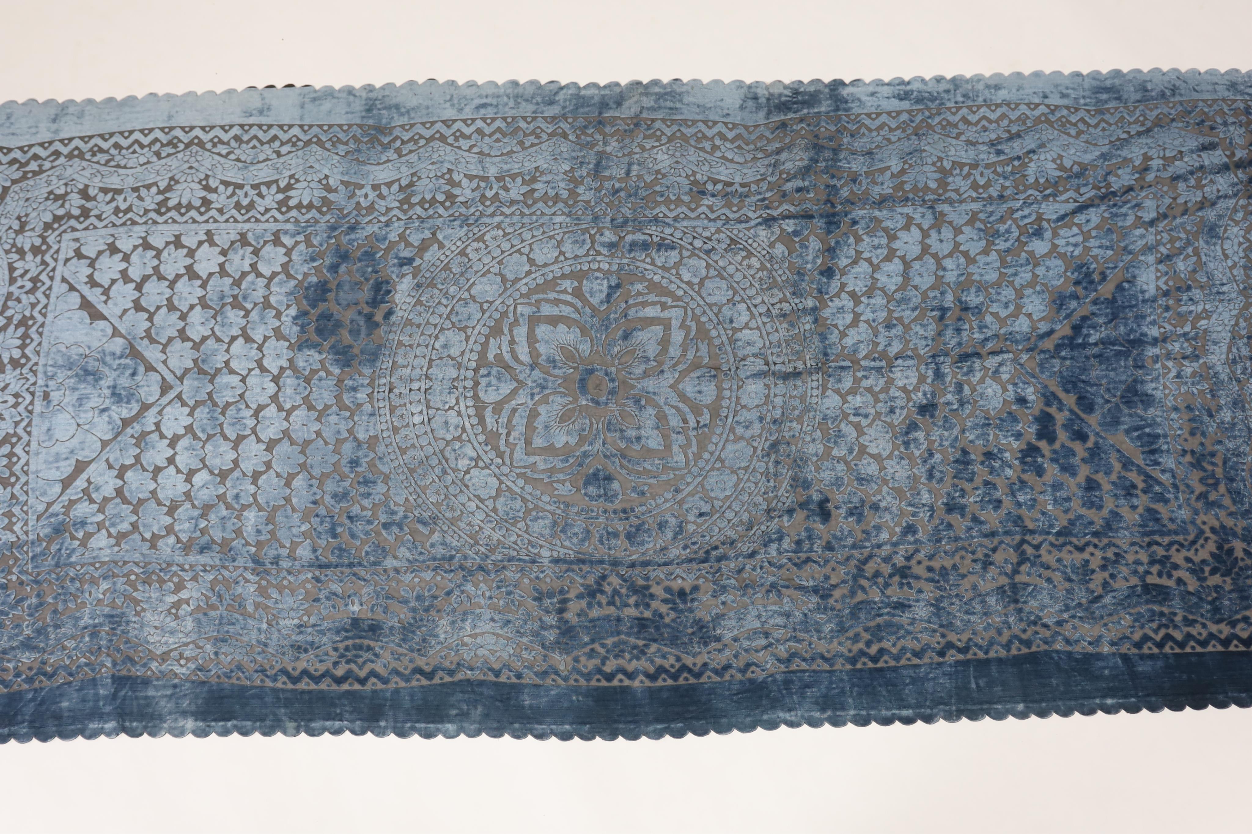 A 20th century blue and black patterned silk cut velvet evening stole with scalloped borders, 102cm wide x 224cm long